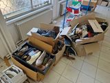 many boxes of shoes sitting on the floor next to a window
