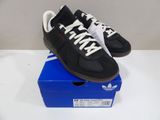 black and white adidas sneakers on top of a blue box