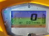 a close up of a yellow motorcycle with a display on it