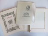 three books are sitting on a white table with a white background