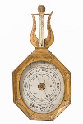 an old clock with a golden frame and a pendulum on it