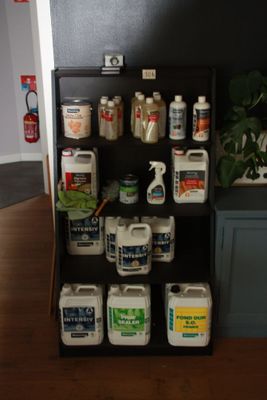 a shelf with several different types of cleaning products on it