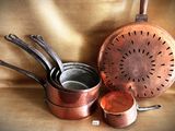 a lot of pots and pans that are on the table