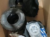 four tires in a cardboard box on the floor
