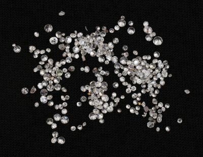 a close up of a bunch of diamonds on a black background