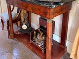 a table with a clock and a vase on it