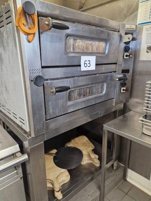 an oven that is sitting in the middle of a kitchen