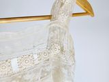 an image of a wedding dress hanging on a hanger