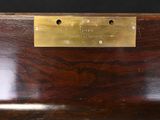 a close up of a wooden bench with a brass plate on it