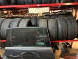 a lot of tires stacked on a shelf in a store