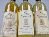 three bottles of white wine sitting next to each other on a table