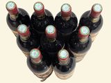 many bottles of wine that are sitting on a table