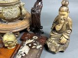 a lot of asian figurines sitting on a table
