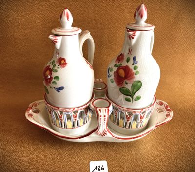 two white vases with red flowers on them sitting on a tray