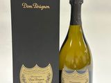 the bottle of champagne is next to the black box