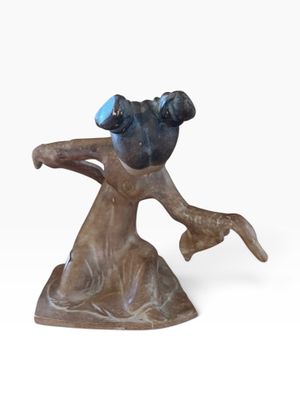 statue of a dog with a blue hat on it ' s head