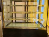 a glass display case in the corner of a room