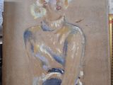 a painting of a woman that is on display in a store