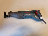 an image of a corded drill is laying on the floor