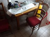a wooden table with a red chair next to it