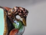 a bird that is sitting on top of a vase