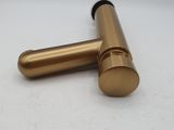 an image of a pair of gold colored metal pipes on a white surface