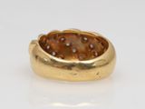 a close up of a gold ring with a brown stone in it