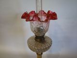 a glass vase with red flowers in it on a table