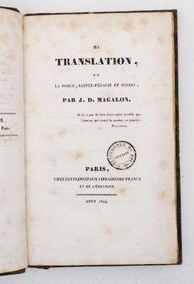 an open book with a stamp on it sitting on a table