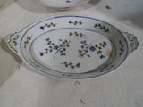 two plates with blue flowers on them on a table