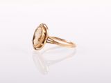a gold ring with an oval stone in the center