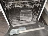 a dishwasher that is open on the floor in the kitchen