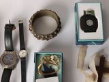 many different types of watches and bracelets laid out on a table