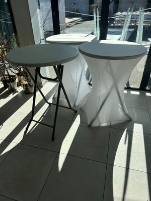 two tables that are sitting in front of a window