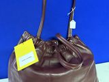 a brown leather purse with a yellow tag on it