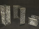 three clear vases sitting next to each other on a black background