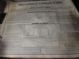 newspapers are sitting on a table with a pen and a calculator