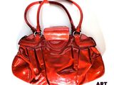 an image of a red purse sitting on top of a white surface