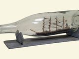 a ship in a glass bottle on a stand