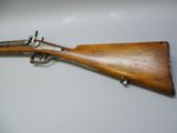 an old rifle with a wooden barrel and a metal muzzle