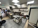 an image of a commercial kitchen with a lot of counter space