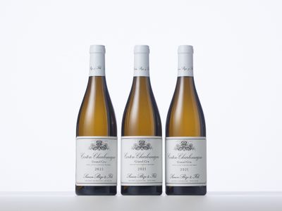 three bottles of wine sitting on top of a white table