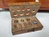 a wooden box with a bunch of nuts inside of it