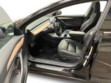 the interior of a car with the door open and the driver ' s seat down