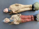 two old dolls that are sitting on a table