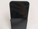 someone is taking a picture of a cell phone on a stand