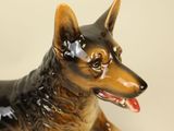 a figurine of a dog with a tag on it ' s collar