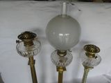 three lamps that are sitting on a white table