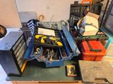 a lot of tools sitting on a workbench in a room