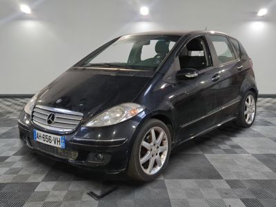a picture of a small black car parked in a garage